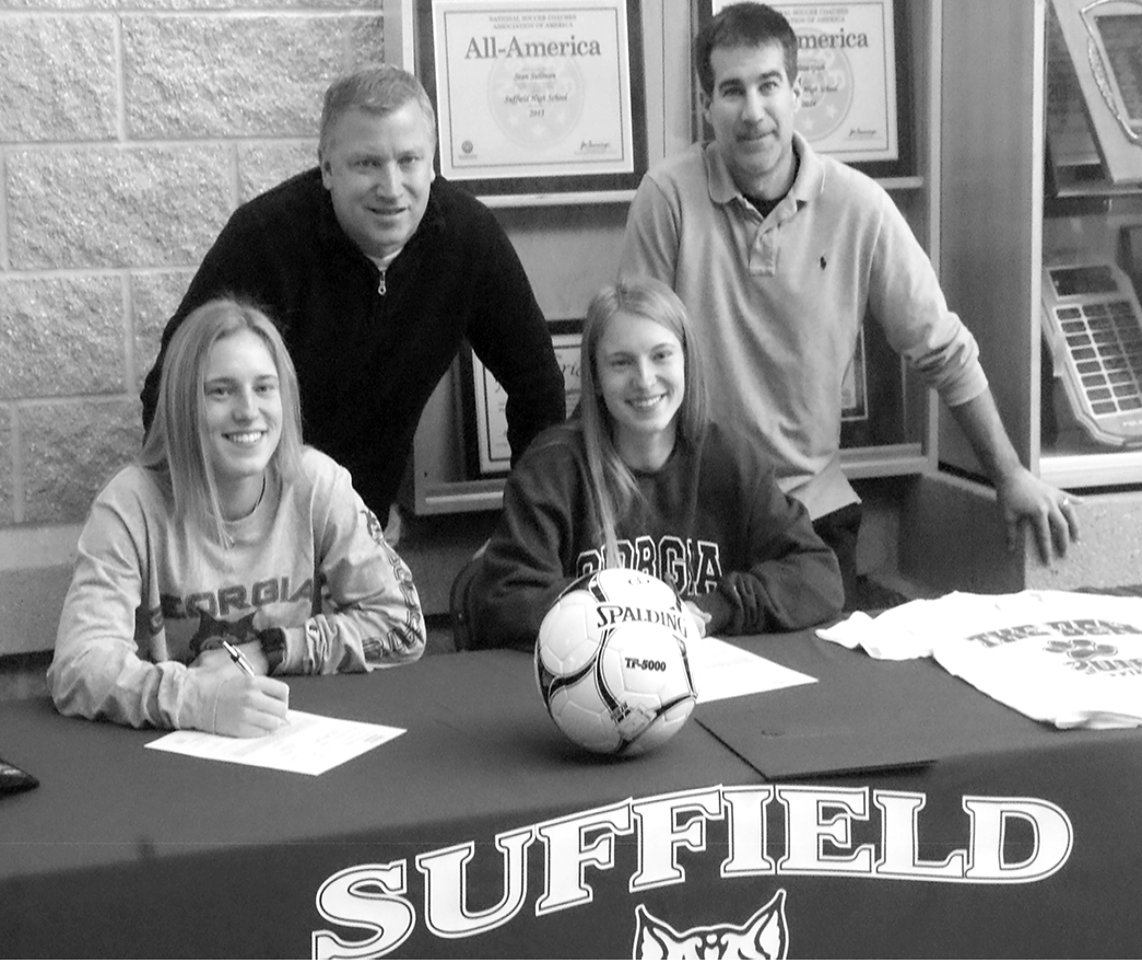 Allyssa, left, and Alexa Bergamini, twin soccer stars at Suffield High School, are pictured signing their commitment to play soccer for Georgia College, where they have been awarded athletic scholarships. With them are SHS Girls Soccer Coach David Sullivan, left, and Athletic Director Michael Bosworth.