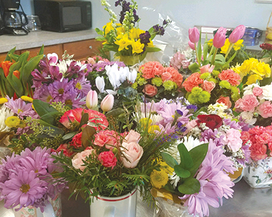 Dozens of floral arrangements stand ready for delivery by Suffield’s Meals on Wheels  volunteers. They are provided each February by the Suffield Garden Club in the late Sue Ann Nealon’s Posies to Go program.