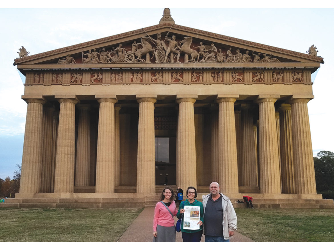 With daughter Mandy, left, and husband Jay, Johanne Presser holds the Observer in front of Nashville’s Parthenon, a reproduction of the ancient original in Athens, Greece.  An art museum now, the building rose in 1897 as a centerpiece of the Tennessee Centennial Exposition.  It was rebuilt in concrete when the 1897 wood rotted. 
